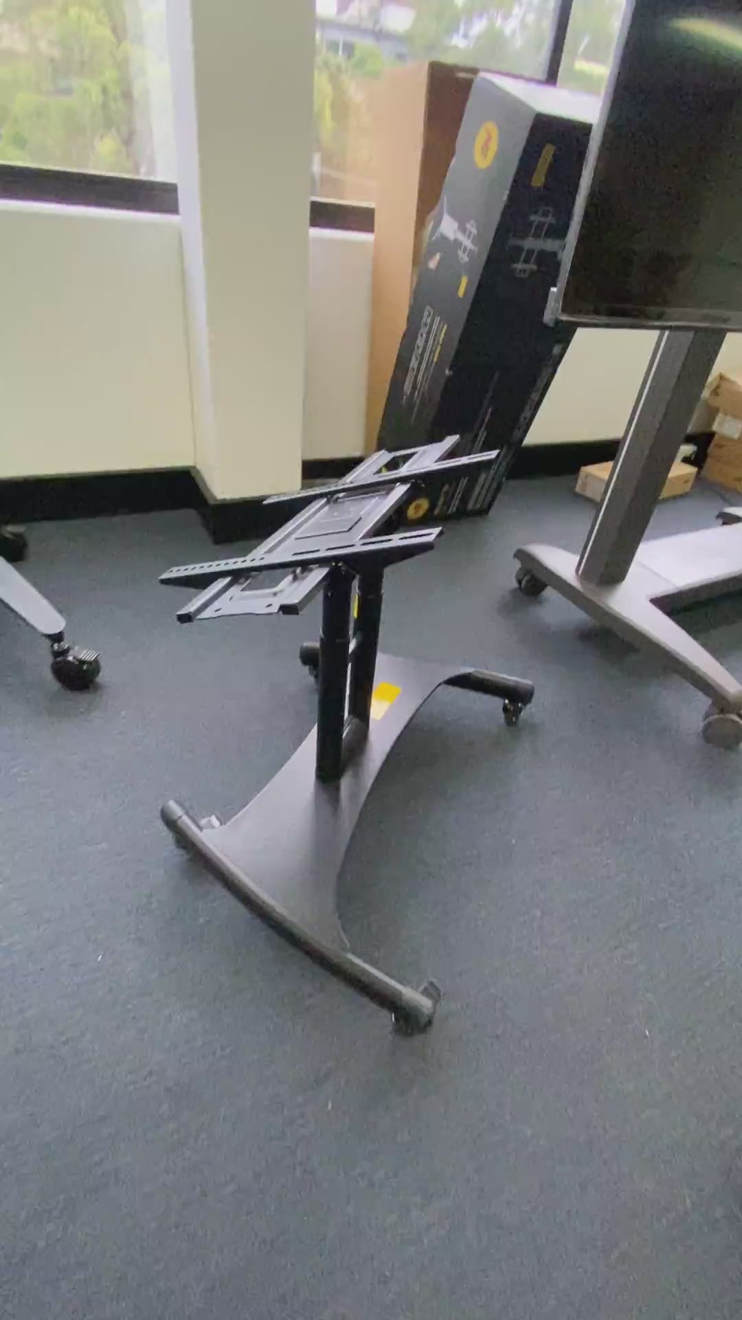 Load video: Steel TV Mobile Cart AVA50 Reduced Height Tilting mobile TV Stand - Black